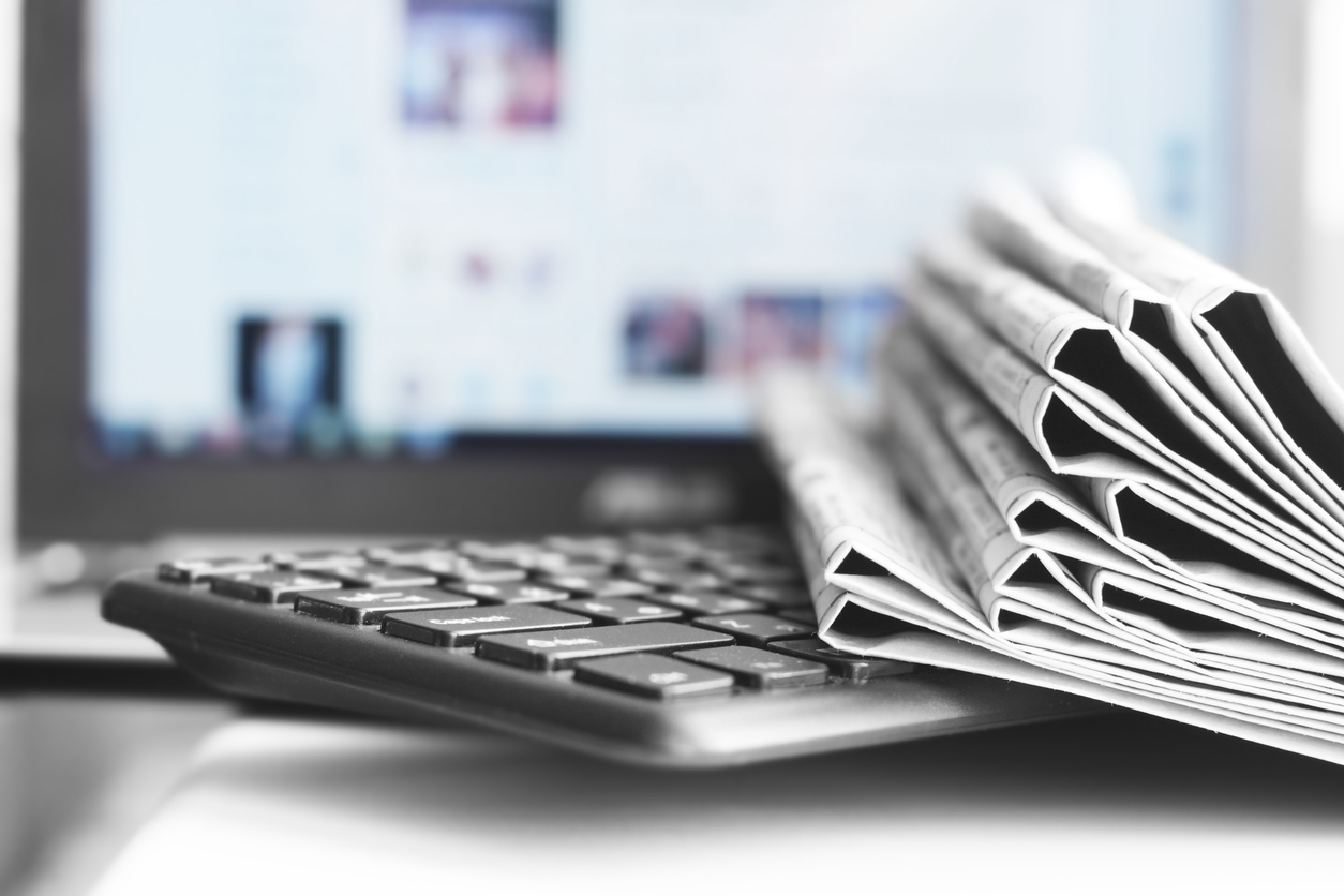 Newspapers and Laptop
