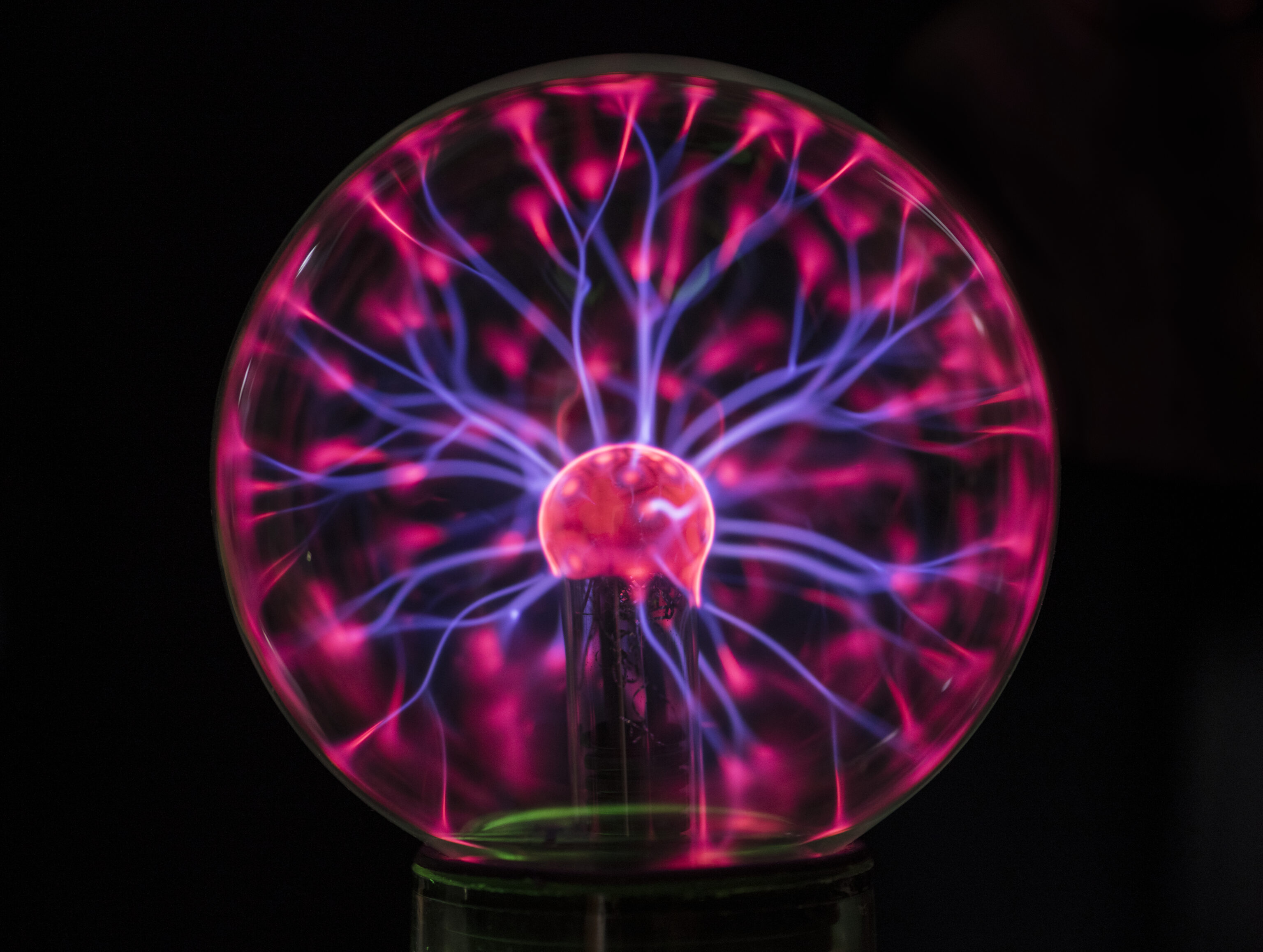 Closeup of a plasma globe in the darkness